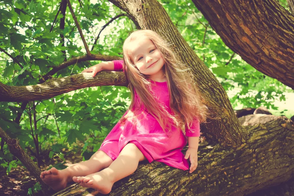 Girl Sitting on Tree Pic